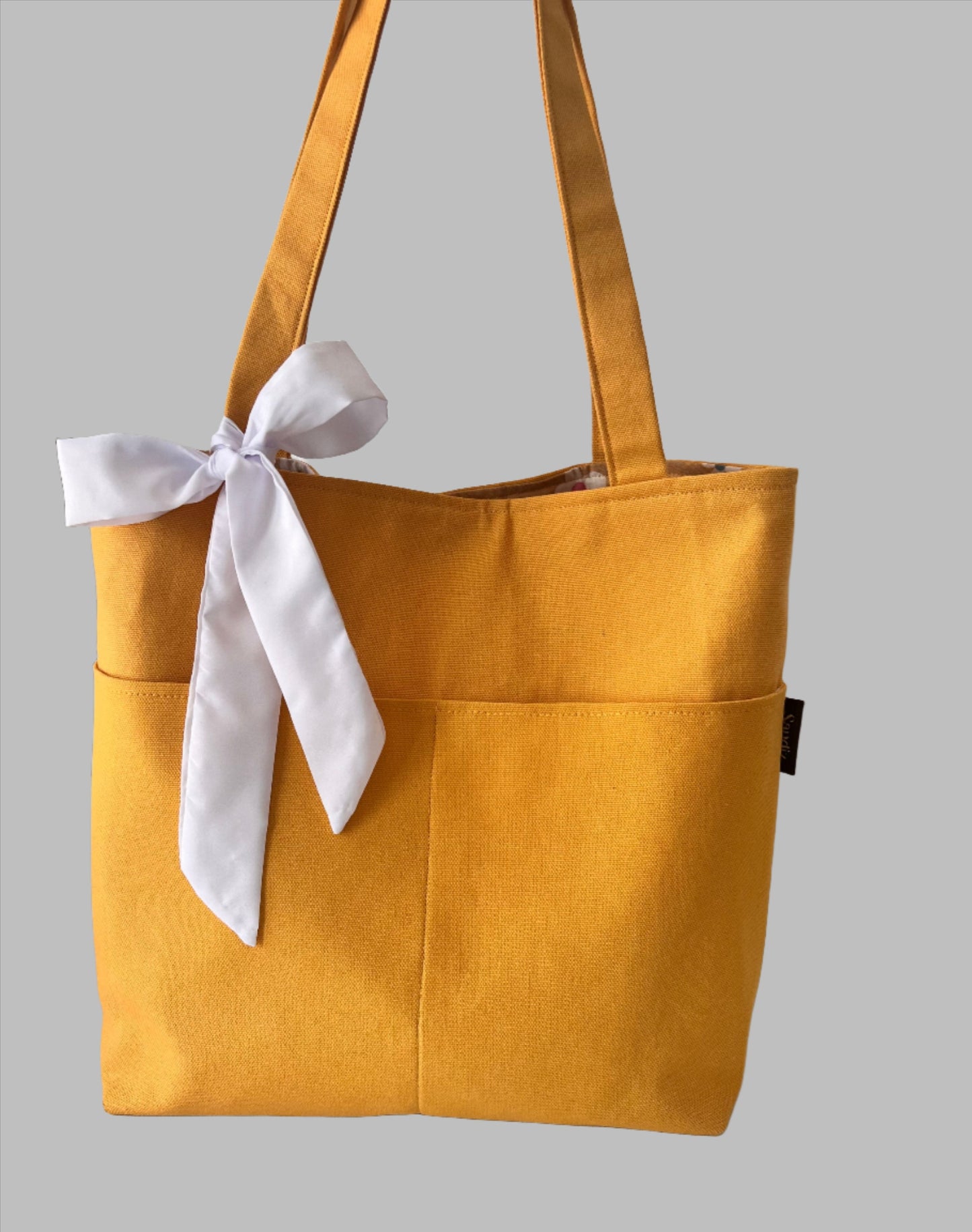 
Gold Handamde Tote Bags with white 
sandiz handmade bags

Tote Bag, Shoulder Bag, women bag, handmade bag, Canvas tote, Reusable tote, Eco-friendly tote, Cotton tote, Custom tote, Tote bag with pockets, Beach tote, small tote bag, Tote bag for work, Tote bag for school, Tote bag for groceries, Tote bag with long handles, yellow bag