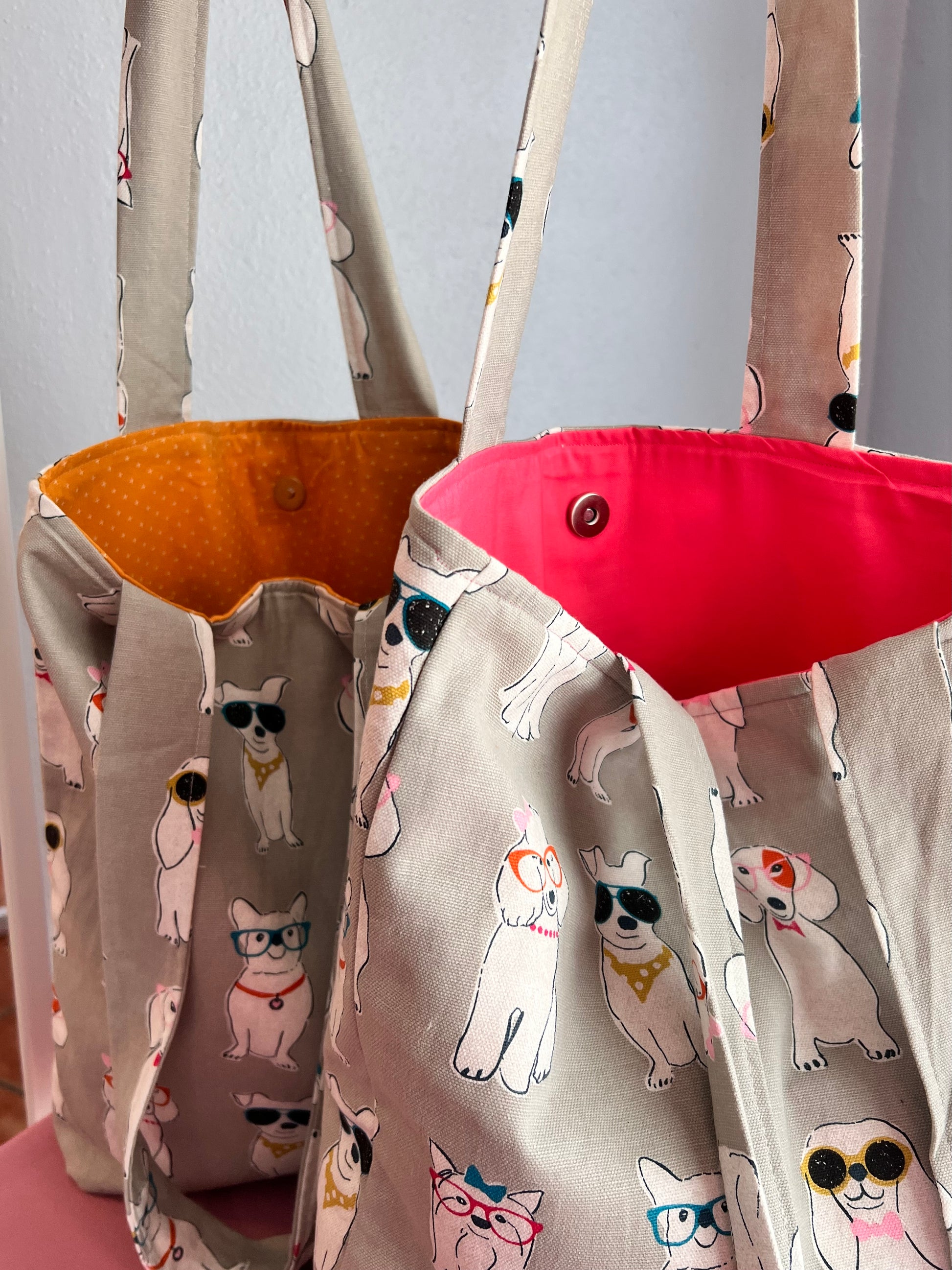 magnetic button closure on dog print shoulder tote bag in orange and red